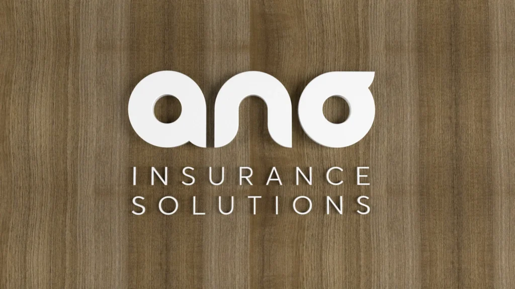 ANO Insurance Solutions white logo mounted on wooden wall background
