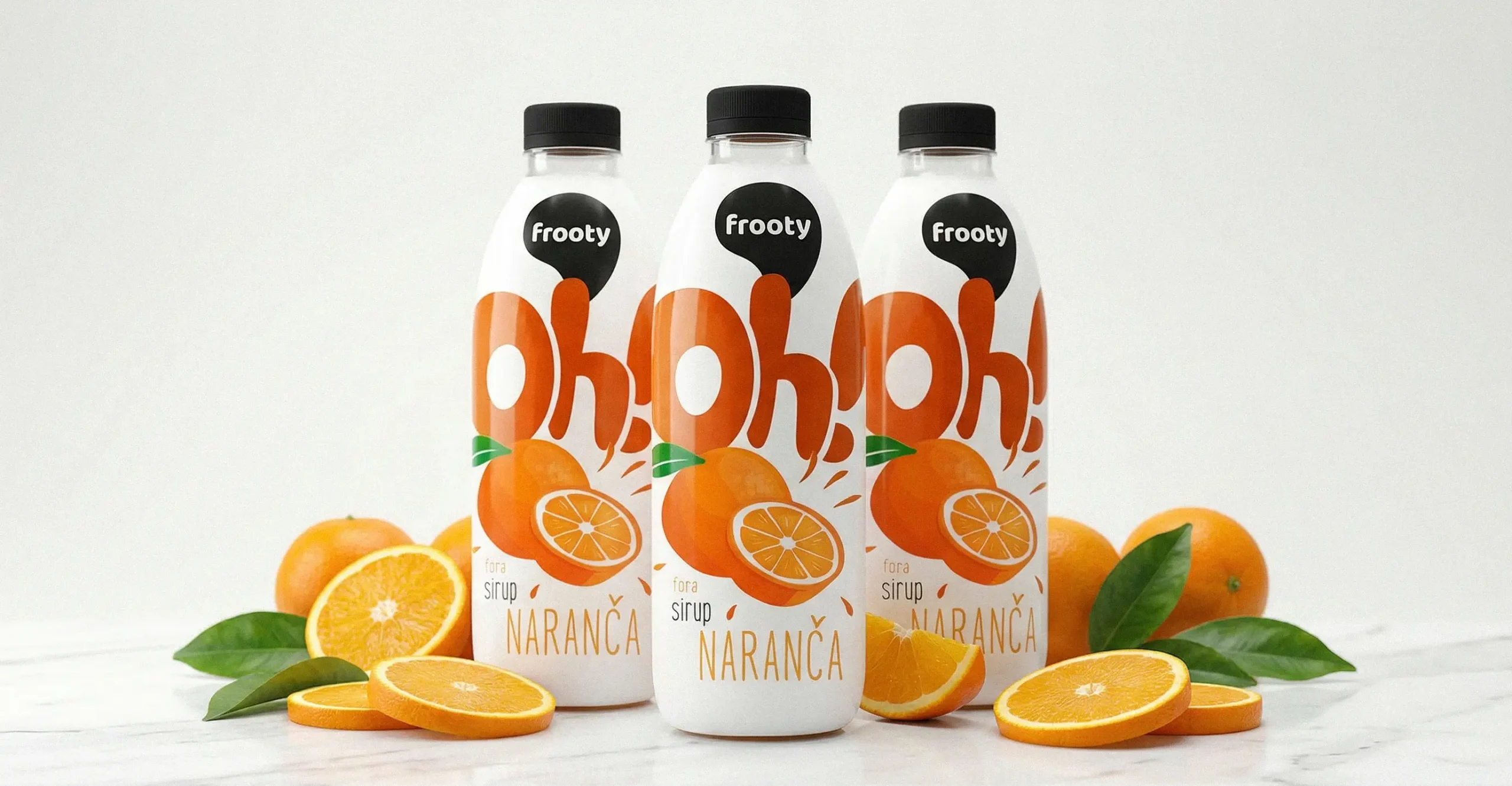 Frooty Oh! orange syrup bottles with fresh sliced oranges and green leaves