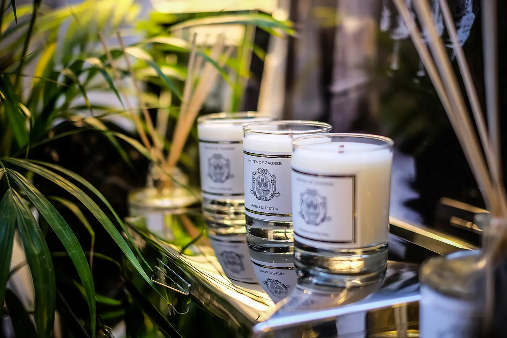 Notes of Zagreb Porta di Pietra luxury scented candles displayed on mirrored tray