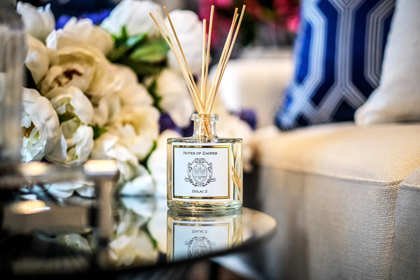 Notes of Zagreb Dolac 2 reed diffuser on glass table with white flowers