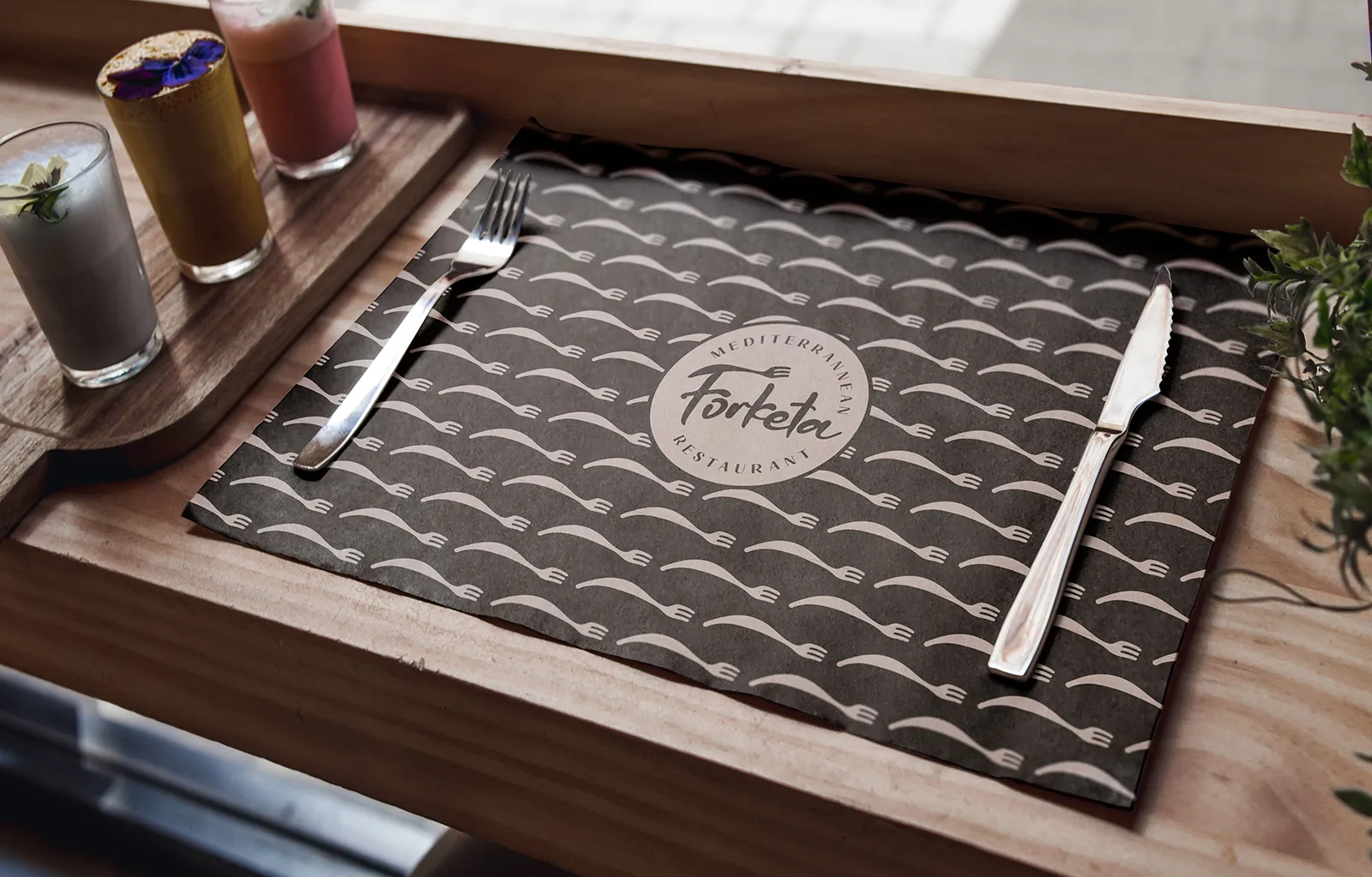 Forketa Mediterranean Restaurant branded placemat with fork and knife on wooden table