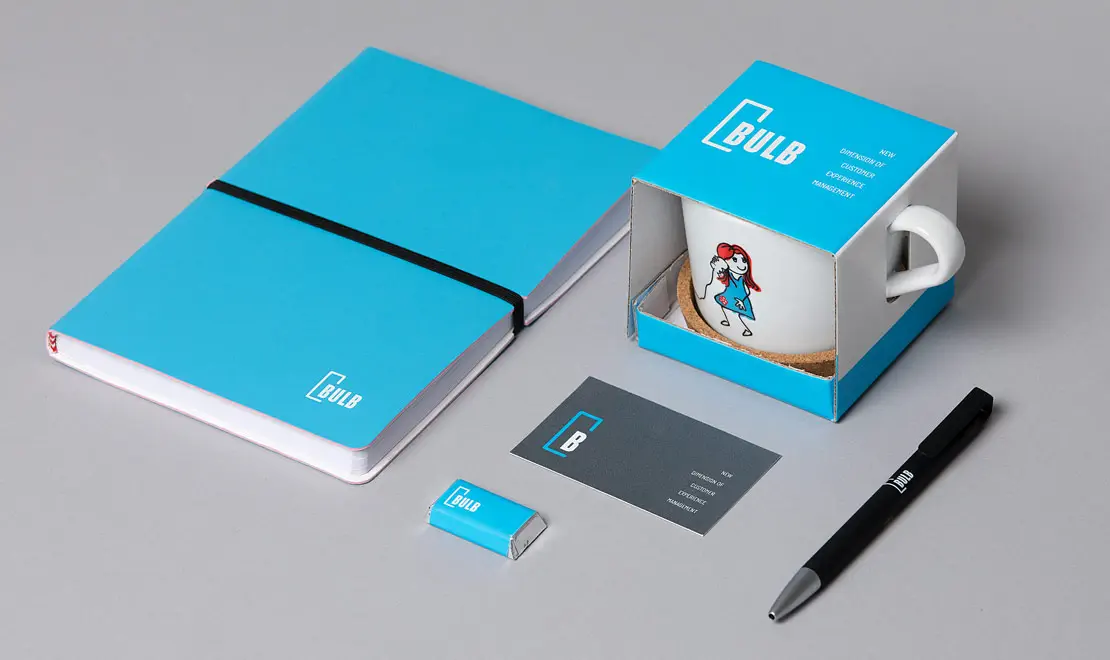 Bulb brand identity stationery set with notebook, mug, business card, and pen