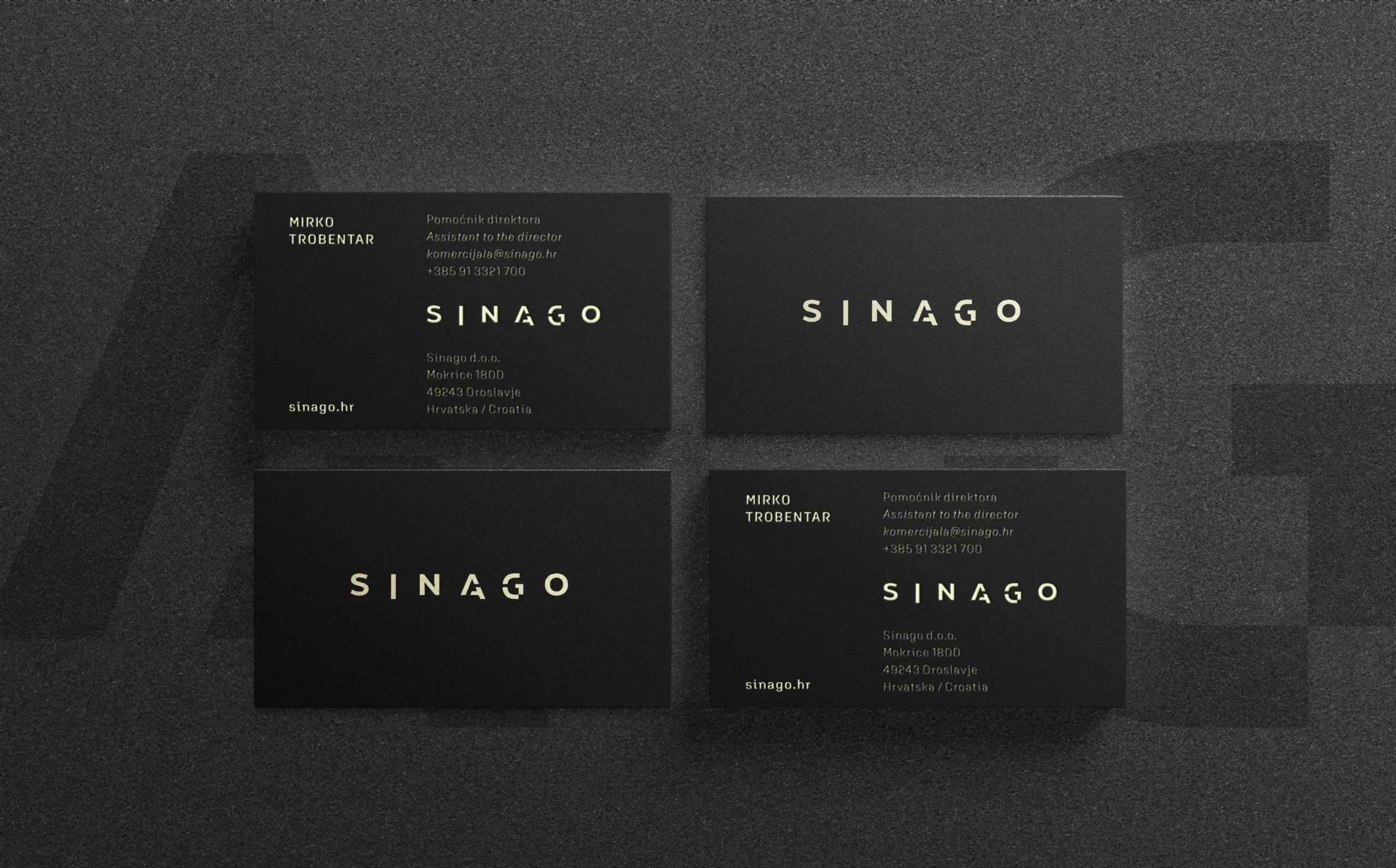 Dark minimalist business cards for Sinago company featuring gold foil logo typography